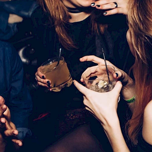The image shows people enjoying drinks and laughing together, with close-up shots of their hands holding glasses.
